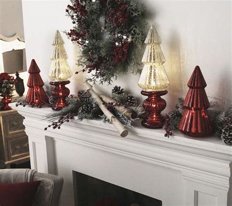 A Mantel With Candles And Christmas Decorations On It