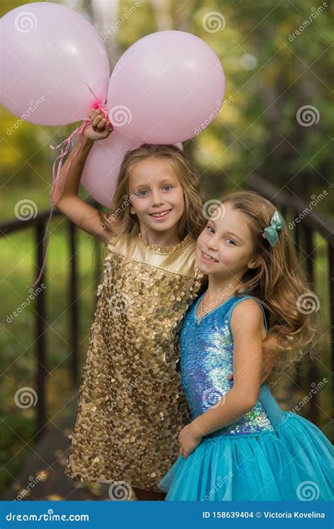 Happy Girl Friends At A Birthday Party With Balloons Portrait Of