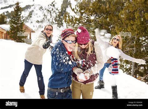 Family having snowball fight together Stock Photo - Alamy