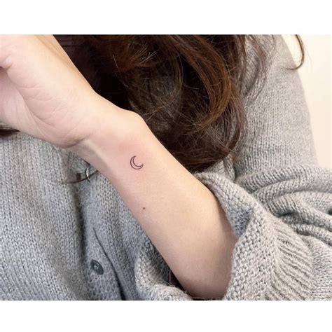 Minimalistic Style Crescent Moon Tattoo Located On The