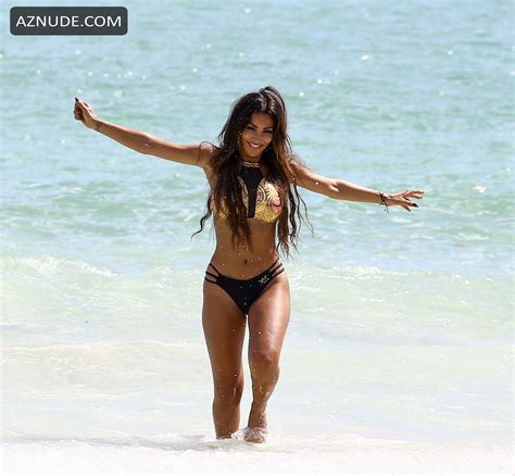 Metisha Schaefer In A Black And Gold Bikini While Doing A Photoshoot On