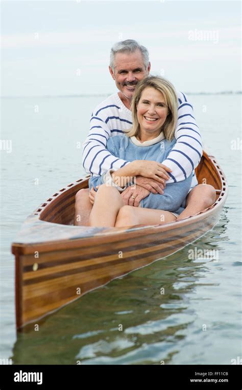 Older Caucasian Couple Hugging In Canoe Stock Photo Alamy