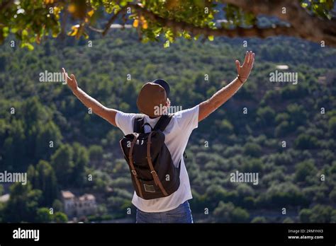 Back View Of Unrecognizable Male Hiker With Rucksack Standing Against