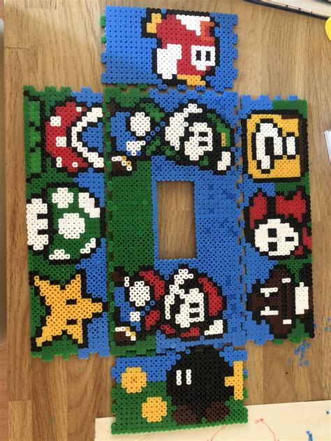 The Letter O Is Made Out Of Perler Beads And Has Marios Characters On It