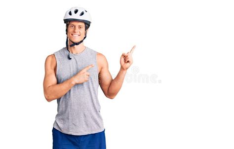 Young Handsome Man Wearing Bike Helmet Smiling And Looking At The