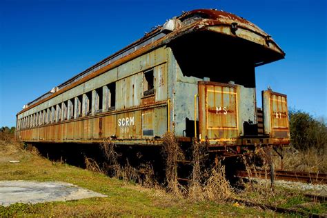 An Abandoned Passenger Train Car Along Highway In Conway South