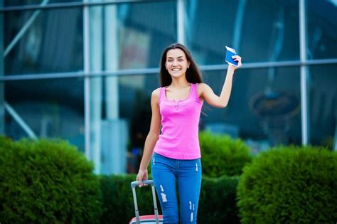 Premium Photo Woman Walk Near Airport With Suitcase Passport And