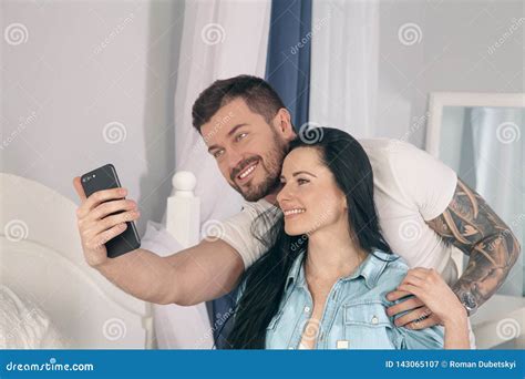 Young Beautiful And Loving Couple Take Selfie Picture On Smartphone