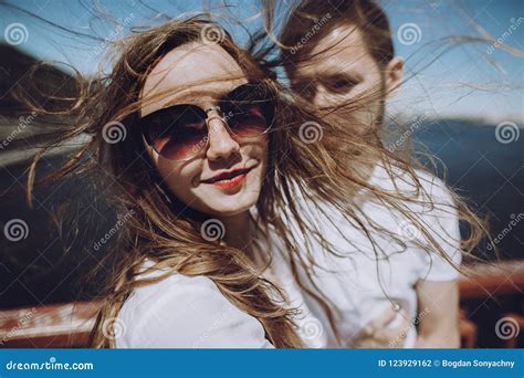 Happy Woman With Windy Hair In Sunglasses Smiling Stylish Couple In