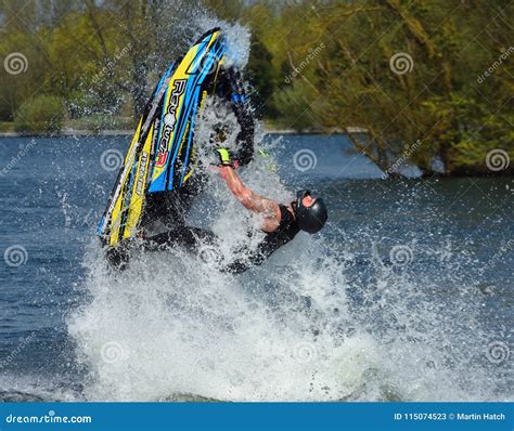 Freestyle Jet Skier Performing Back Flip Creating At Lot Of Spray