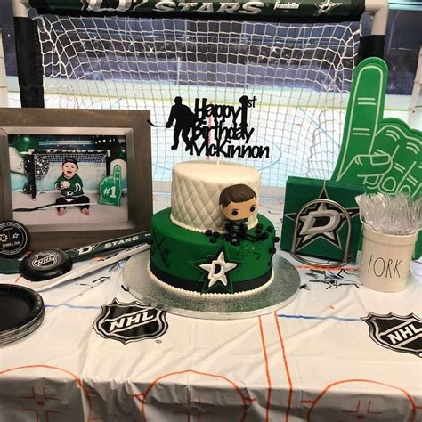 A Hockey Themed Birthday Cake Sits On A Table Next To An Ice Hockey