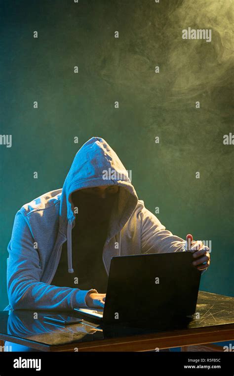 Hooded Computer Hacker Stealing Information With Laptop Stock Photo Alamy