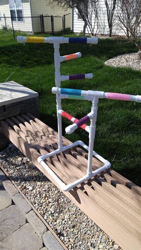 A Ladder Made Out Of Plastic Tubes On Top Of A Wooden Deck In Front Of