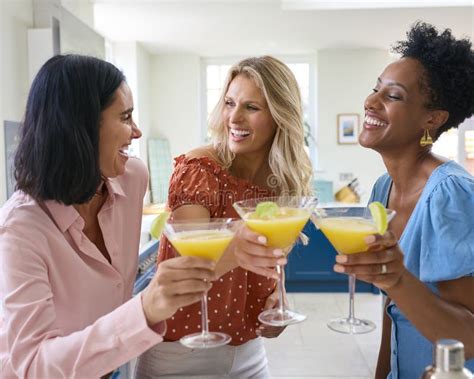 Three Mature Female Friends At Home Celebrating With Cocktails Together Stock Image Image Of