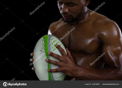 Shirtless Male Rugby Player Holding Ball Stock Photo By Wavebreakmedia