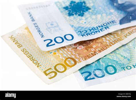 Three Norwegian 200 And 500 Kroner Banknotes On A Plain White