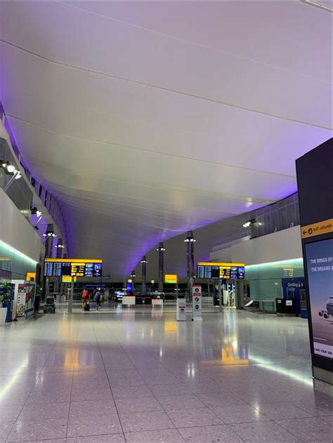 An Empty Airport Terminal With Purple Lighting