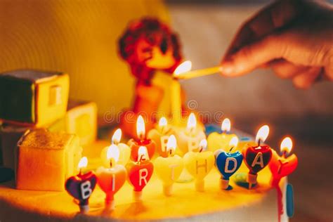 Happy Birthday Written In Lit Candles On Colorful Background Stock