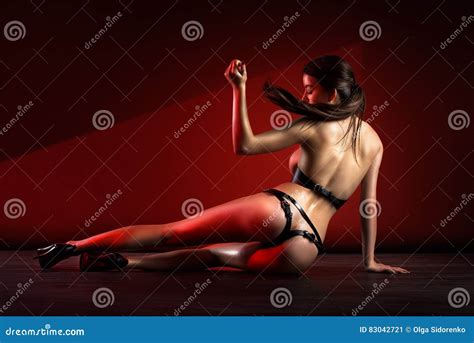 Beautiful Naked Woman Posing In Leather Lingerie Isolated On Red Background Stock Image Image