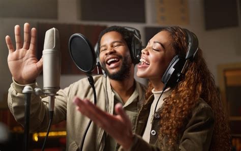 Premium Photo | Music streaming and black couple recording in studio ...