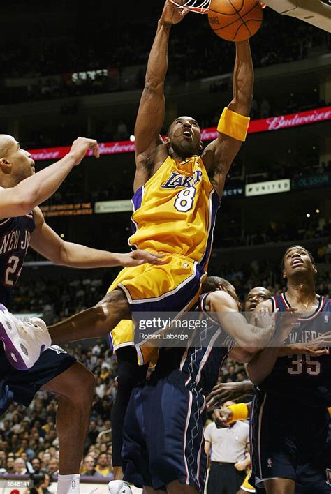 Kobe Bryant Of The Los Angeles Lakers Dunks Against The New Jersey