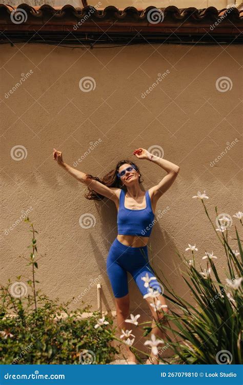 Happy Young Caucasian Woman Enjoying Sunshine With Closed Eyes