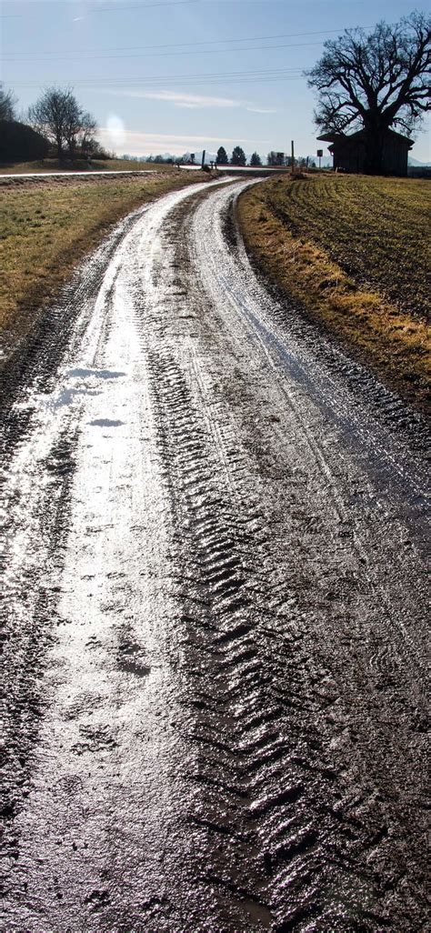 Download Wet Road Dirty Mud Tire Tracks Wallpaper | Wallpapers.com 