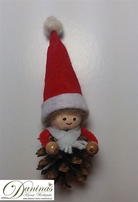 A Small Christmas Ornament With A Red And White Hat