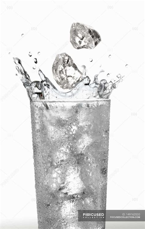 Ice Cubes Falling Into Glass Of Water Nutrition Aaa Stock Photo