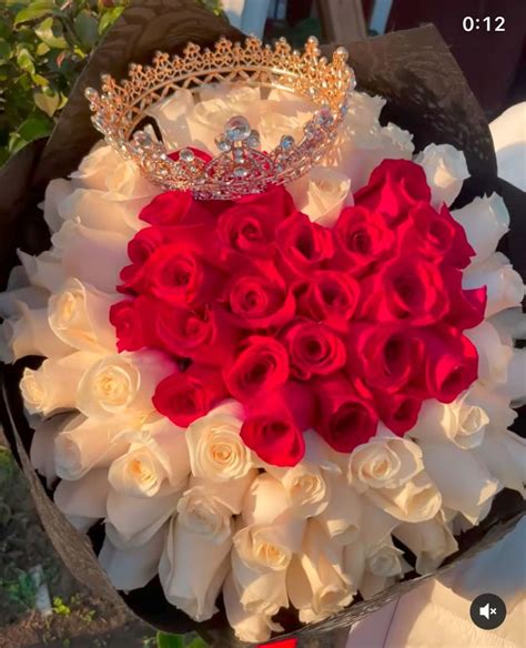 A Bouquet Of White And Red Roses With A Tiara