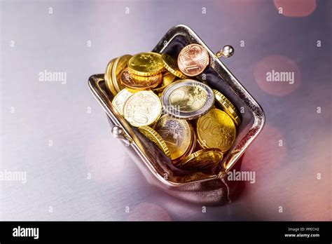 Wallet filled with many coins | usage worldwide Stock Photo - Alamy