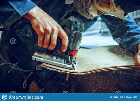 Carpenter Using Circular Saw For Cutting Wooden Boards Stock Image