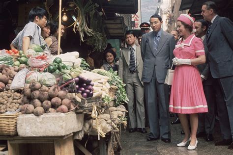 Queen Elizabeth II Visits A Market Stall During A Royal Tour Of Hong