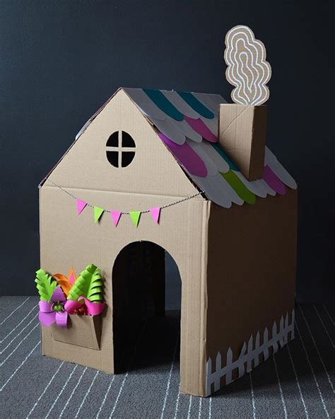 a cardboard house with decorations on the roof and side walls, made to ...