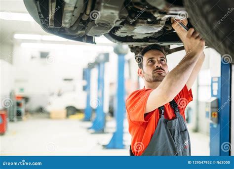 Profecional Car Mechanic Changing Motor Oil At Maintenance Repair