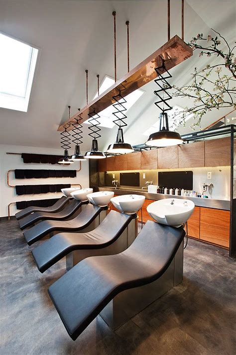 A Long Counter With Several Sinks And Lights Hanging From It S Ceiling In A Modern Kitchen