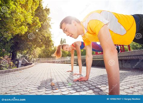 Sporty Young Couple Doing Plank Exercise Outdoors Stock Image Image Of Girl Physical 109867827