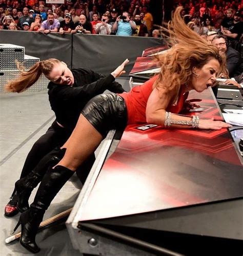 Two Women In Leather Outfits Are On The Edge Of A Wrestling Ring