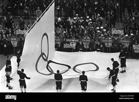 The Olympic Flag Is Lowered During The Closing Ceremony For The X Olympic Winter Games In