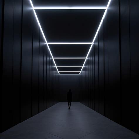 Premium Ai Image A Person Walking Down A Dark Hallway With Bright Lights