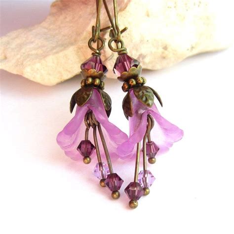 The Earrings Are Adorned With Purple Glass Flowers