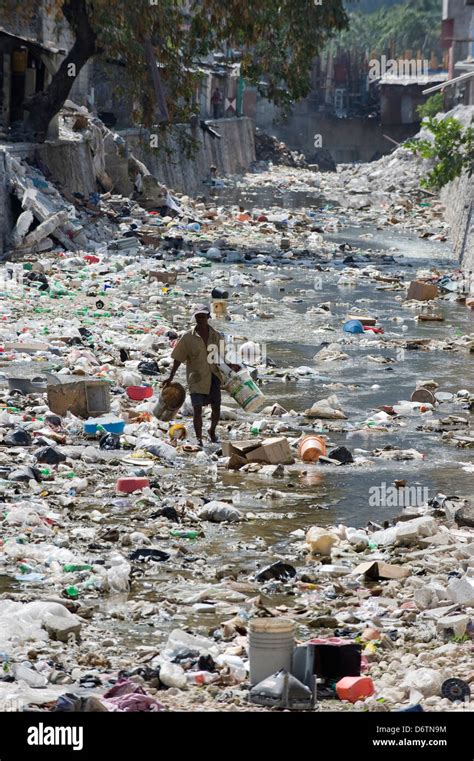 Man Looking A Garbage Filled River Port Au Prince Haiti Caribbean