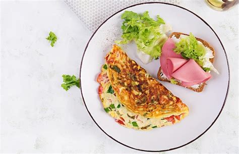 Premium Photo Omelette With Tomatoes Cheese Green Onion And Sandwich