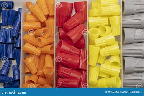 Many Colored Wire Nuts In Plastic Box On White Background Tool For