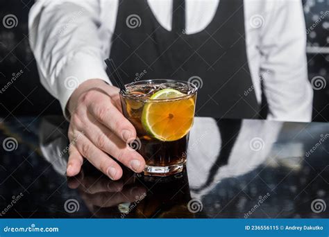 The Hand Of A Professional Bartender Serves An Alcoholic Beverage