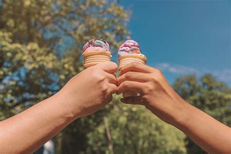 Premium Photo Woman S Hands Holding Melting Ice Cream Waffle Cone In