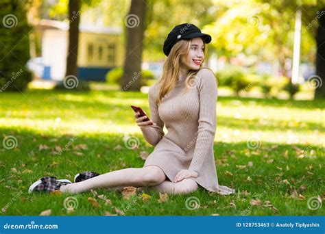 Beautiful Woman Walks Through City Streets Between Building Stock Image