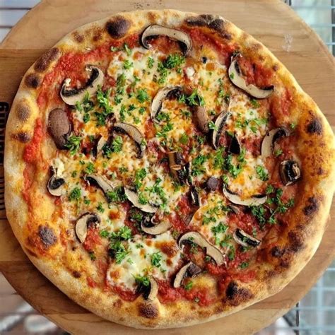 A Pizza Sitting On Top Of A Wooden Cutting Board