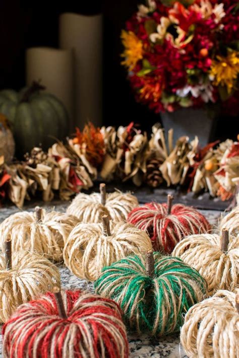 Twine Pumpkins Are Stacked On Top Of Each Other In Different Colors And