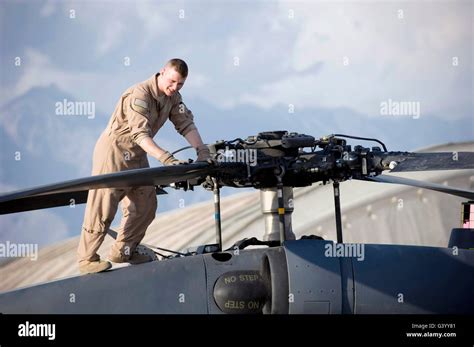 An Airman checks the main rotors of an HH-60G Pave Hawk Stock Photo - Alamy
